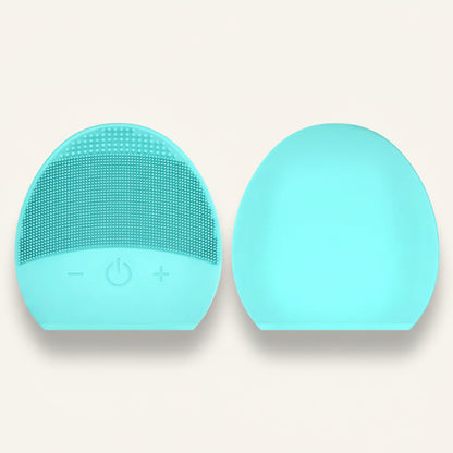 Two turquoise silicone face cleaning brushes on a white background