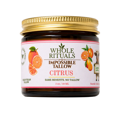 Jar of Whole Rituals Impossible Tallow Citrus product with a gold lid on a white background