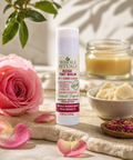 Whole Rituals lip balm with a pink rose and rose petals on a natural background