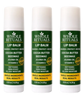 Three Whole Rituals lip balms on a white background