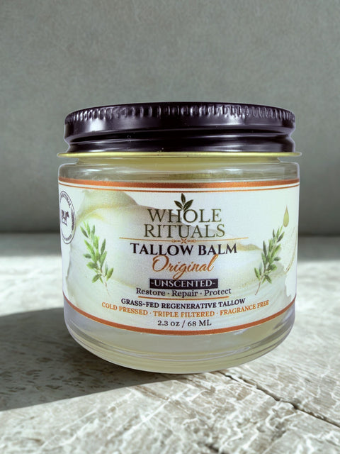 Jar of Whole Rituals Tallow Balm on a textured surface with a neutral background